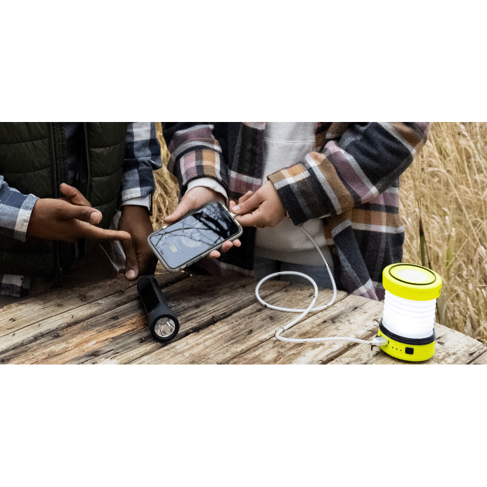 PUC 150 expandable lantern yellow charging phone on table