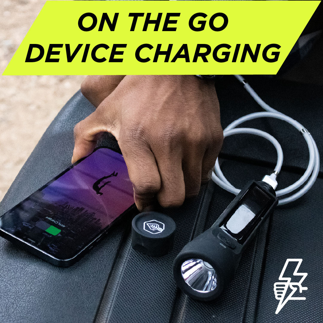 Journey 200 Solar Flashlight black charging phone on truck bed