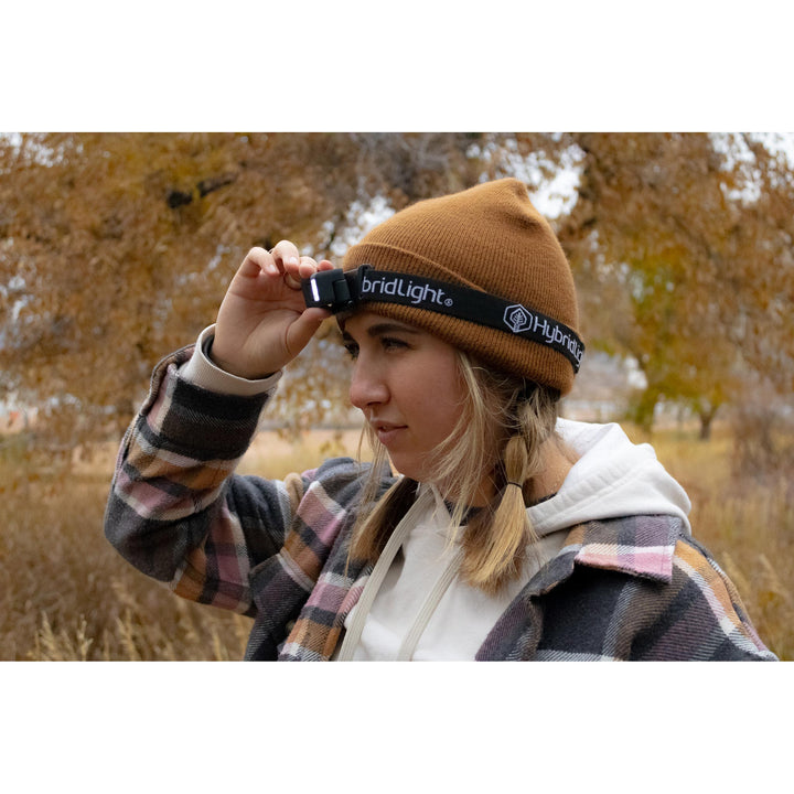 NAV Headlamp on head outside in woods